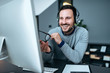 © bnenin - Happy business man with headset at workplace in front of the computer.