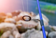 Fishing Rod Spinning Ring With The Line Close-up. Fishing Rod. Fishing Rod Rings Selective Focus And Shallow Depth Of Field .Fishing Tackle. Fishing Spinning Reel. Soft Lighting