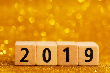 Sticker - Horisontal numbers of 2019 on golden sparkling background. Place for text. Festive concept.