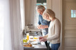 © fizkes - Happy senior husband and wife prepare healthy breakfast on kitchen, smiling aged couple make vegetarian tasty food at home, elderly man and woman cook at shared house spending morning together