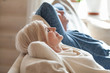 © fizkes - Close up of peaceful aged couple lying with eyes closed relaxing on cozy sofa, calm senior husband and wife nap on couch at home seeing dreams, elderly man and woman rest spending weekend indoors