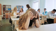 © Довидович Михаил - The girl is a schoolgirl crying in class and her classmates console her.