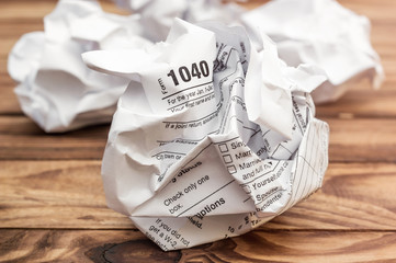 Poster - Crumpled sheet of tax form on the table. Close up.