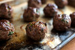 © Andrew Scrivani - Close up of meatballs on cutting board