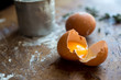© Andrew Scrivani - Close up of broken egg on wooden table