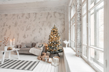 Wall Mural - Light living room with Christmas tree. Comfortable sofa, high large Windows. Light white brick wall.