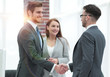 © ASDF - handshake business partners at a meeting