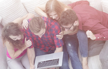 Poster - group of friends looking at the photo on the laptop.