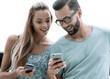 © ASDF - couple of tourists looking at their smartphone screens.