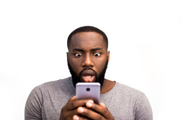 angry face of a man of african american appearance against a white studio background. developer of a