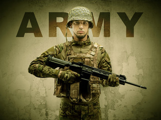 Uniformed armed soldier with damaged wall background
