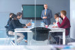© luckybusiness - Workers discus about business at meeting