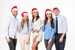 © BestForYou - Group of happy young people in santa hats on white background.