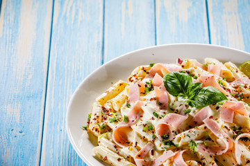 Pasta carbonara on wooden table