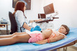 Medical exam of a little girl by ultrasound equipment