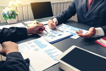 Group of business people meeting analyzing financial documents