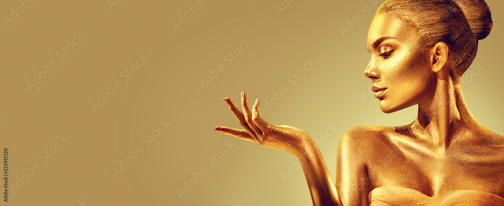 Golden woman. Beauty fashion model girl with golden skin, makeup, hair and jewellery on gold background. Fashion art portrait - obrazy, fototapety, plakaty 