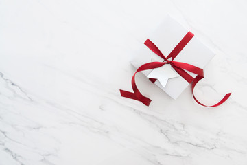 Wall Mural - gift on white marble background top view. birthday, anniversary, valentine's, christmas, new year ho