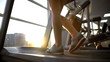© motortion - Female athlete legs walking treadmill machine, cardio exercise, active lifestyle