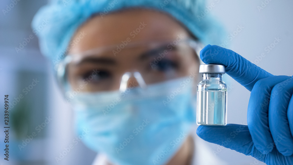 Female biologist holding bottle with new medication, vaccination lab research - obrazy, fototapety, plakaty 