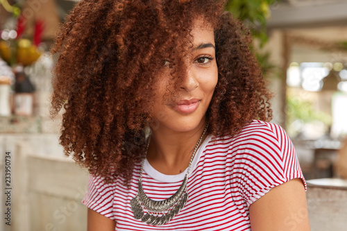 Headshot Of Attractive Woman With Curly Hair Looks
