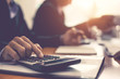 © amnaj - Close up businessman hand using calculator at meeting.