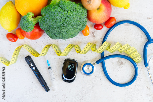 Cuadros en Lienzo raw vegetables with blood glucose meter, syringe, lancet and stethoscope on desk