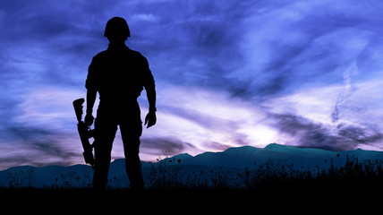 Silhouette of military soldier or officer with weapons at night