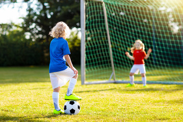 Wall Mural - Kids play football. Child at soccer field.