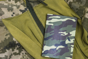 Wall Mural - Military clothing with a bible on it. The symbol of the army and faith.