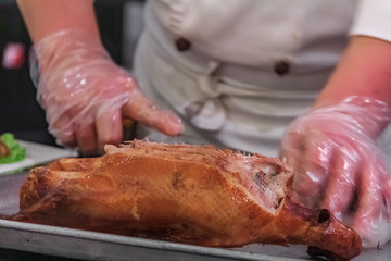 Traditional Chinese Roast Duck or Da Dong Kaoya served tableside at a Chinese restaurant