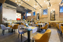Interior Of A Modern Hotel Restaurant With Brick Wall
