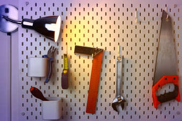 various construction tools hanging on the wall and a glow lamp