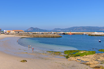 Wall Mural - Beach and fishing harbor in Porto do Son, Galicia, Spain.
