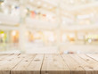 © tortoon - Empty wood table and Blurred background image. supermarket blur background with space display montage for product.