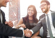 © ASDF - handshake Manager and the client at a meeting in the office lobby.