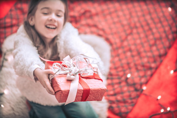 Wall Mural - Christmas and Holiday concept little girl with a gift