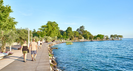 Wall Mural - Lake Garda with nice walkways and beaches at Bardolino in Italy