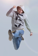 Poster - Funny cheerful happy man jumping in air over gray background