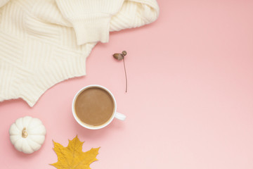 Wall Mural - Cup of coffee and white sweater on pink background