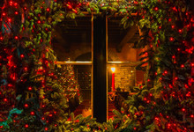 Christmas Tree And Fireplace Seen Through A Wooden Cabin Window Outdoor