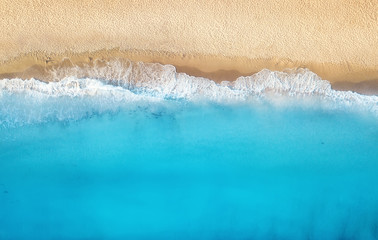 Wall Mural - Beach and waves from top view. Turquoise water background from top view. Summer seascape from air. Top view from drone. Travel concept and idea