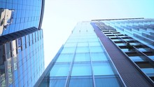 Spinning Footage, Look Up Point Of View, Low Angle Shot Of Tall High Rise Building With Blue Sky