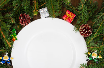 Wall Mural - White plate and spruce branches for New Year and Christmas menu