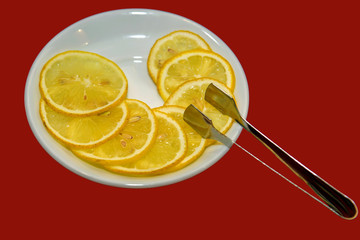 Sliced lemon wedges on a plate. Fruits rich in vitamin C.