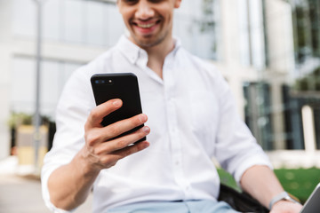 Sticker - Happy young business man using mobile phone