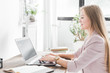 © xartproduction - Young business woman working at home. Creative Scandinavian style workspace