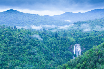 Poster - Aerial view of tropical waterfall in the morning mist.