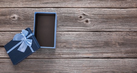 Open gift box on the background of wooden boards.