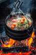 Tasty and homemade hunter's stew on campfire